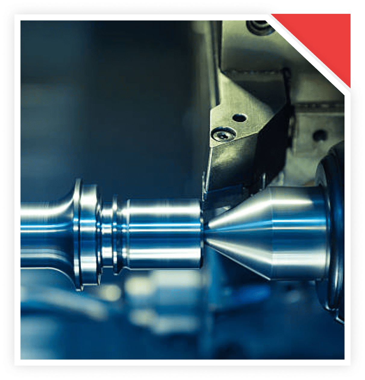 Close-up of a metal lathe shaping a cylindrical metal piece.